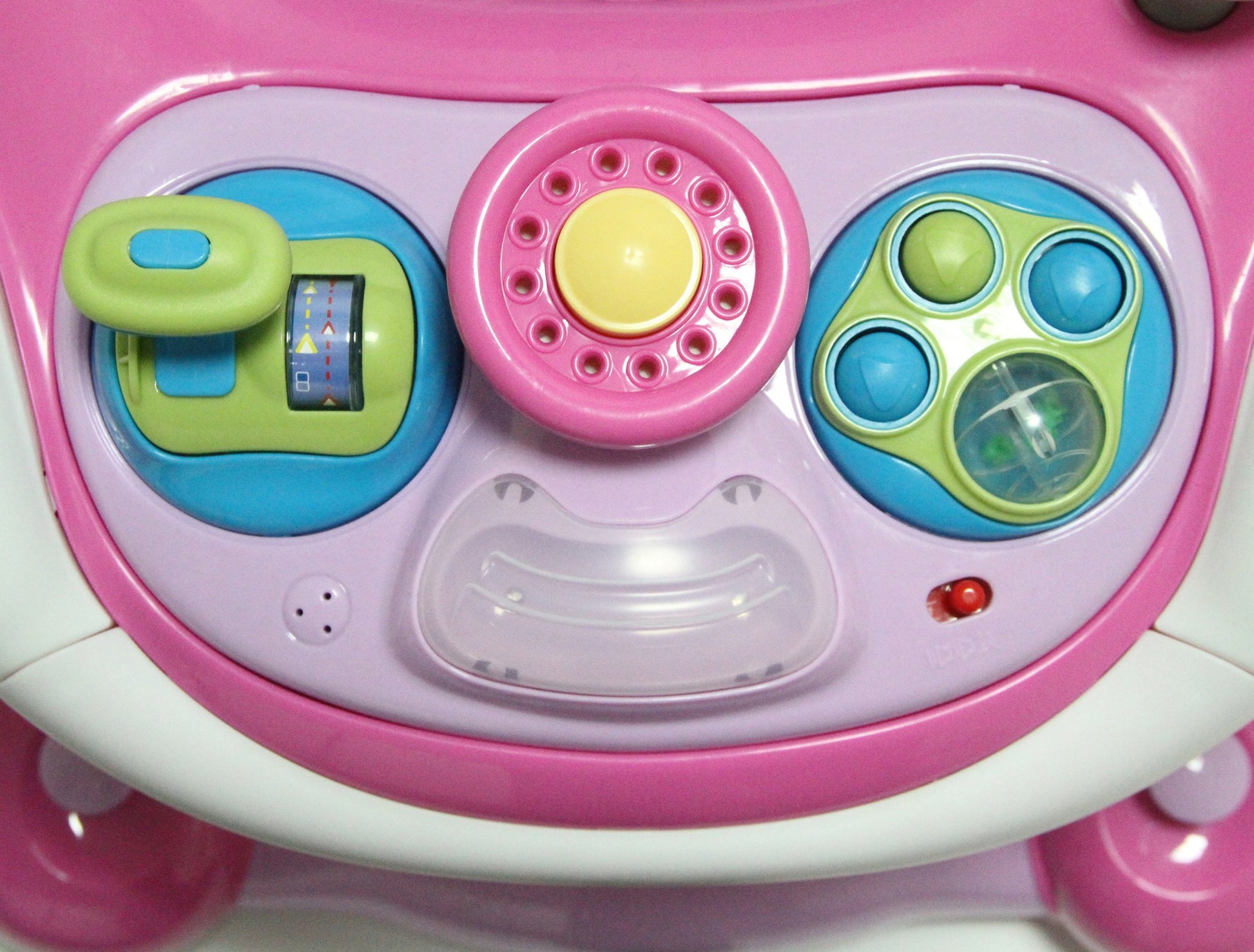 Close-up of a toy car dashboard with colorful buttons and controls.