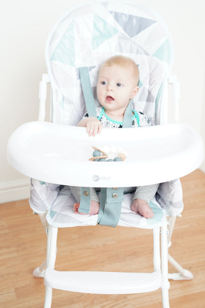 Baby sitting in Pepper highchair with tray, front view