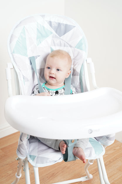 Baby in Pepper highchair with tray, close-up