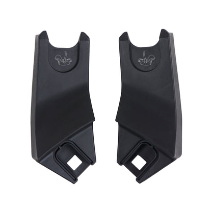Two black plastic car seat anchors on a white background