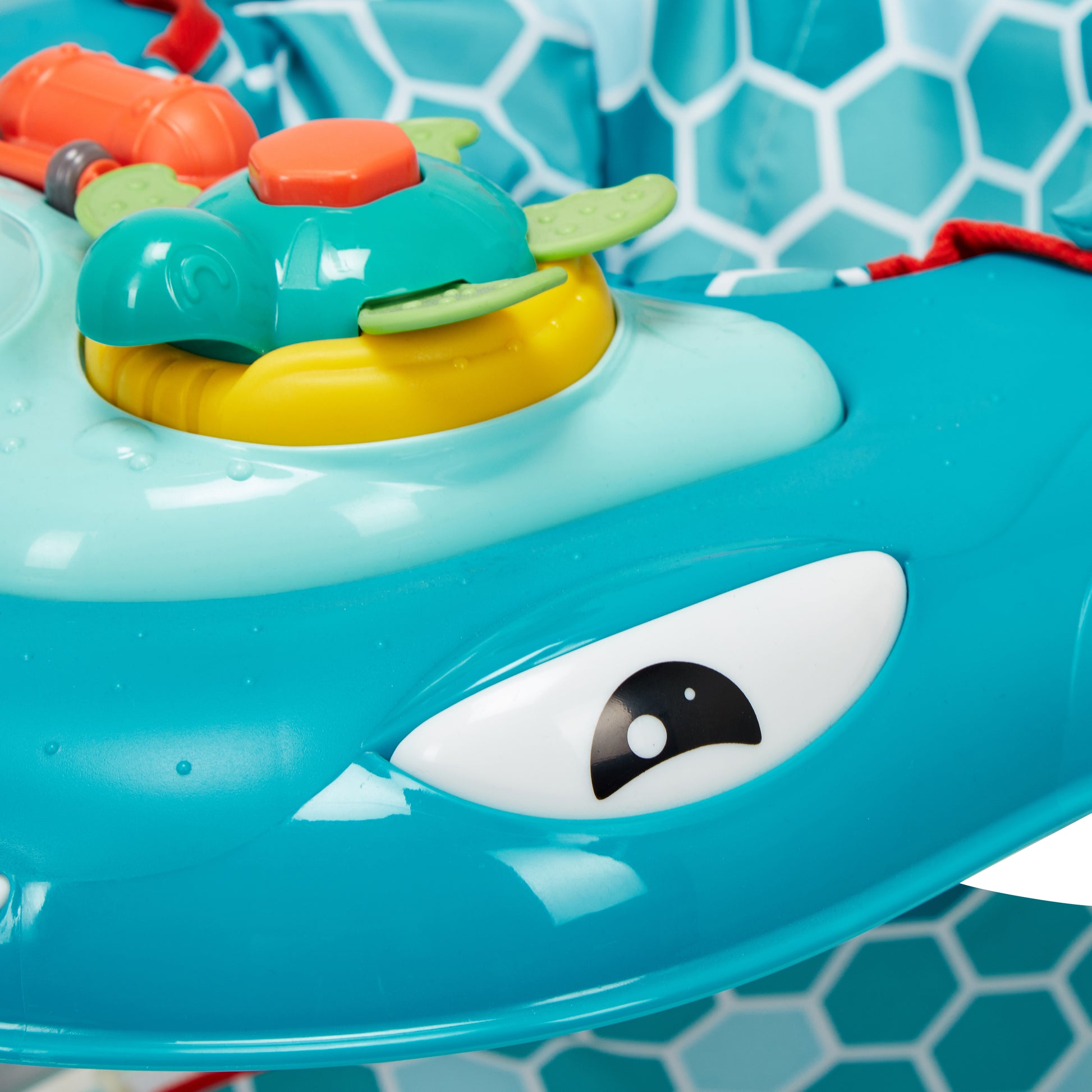 Toy shark with a turtle on top in a pool