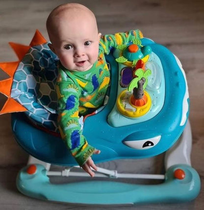 Baby in a colorful dinosaur-themed walker on a wooden floor