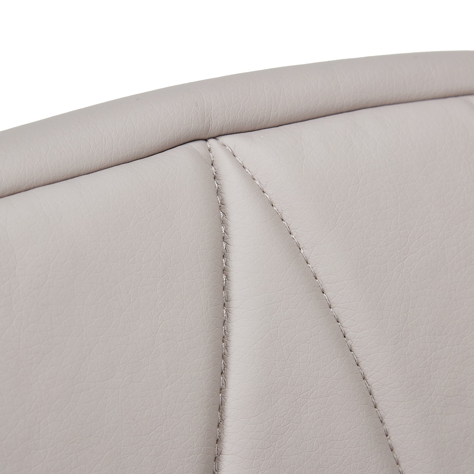 Close-up of beige quilted seat padding and stitching