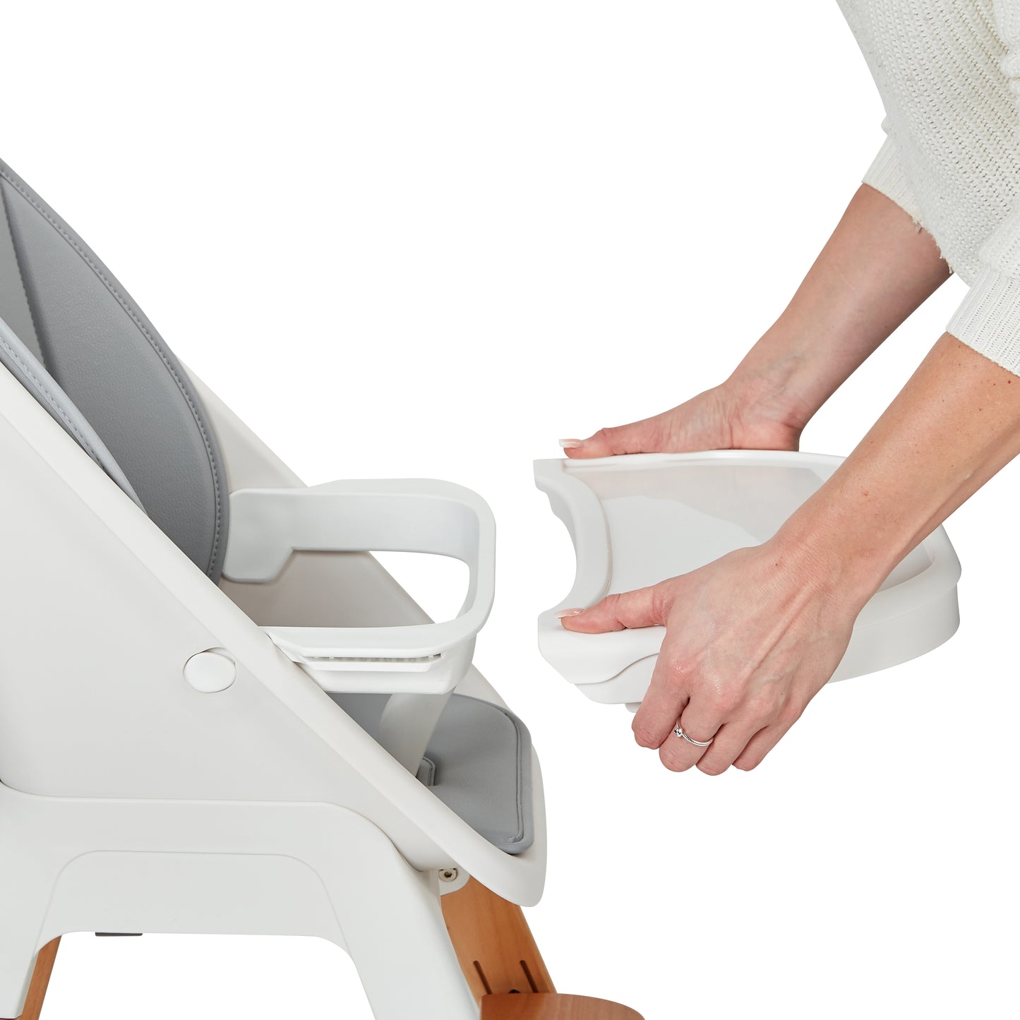 Person adjusting a tray on a chair with a white background