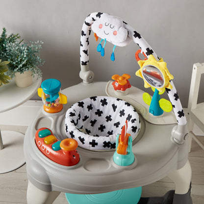 Baby activity center with toys and a cloud-shaped toy on a light gray background