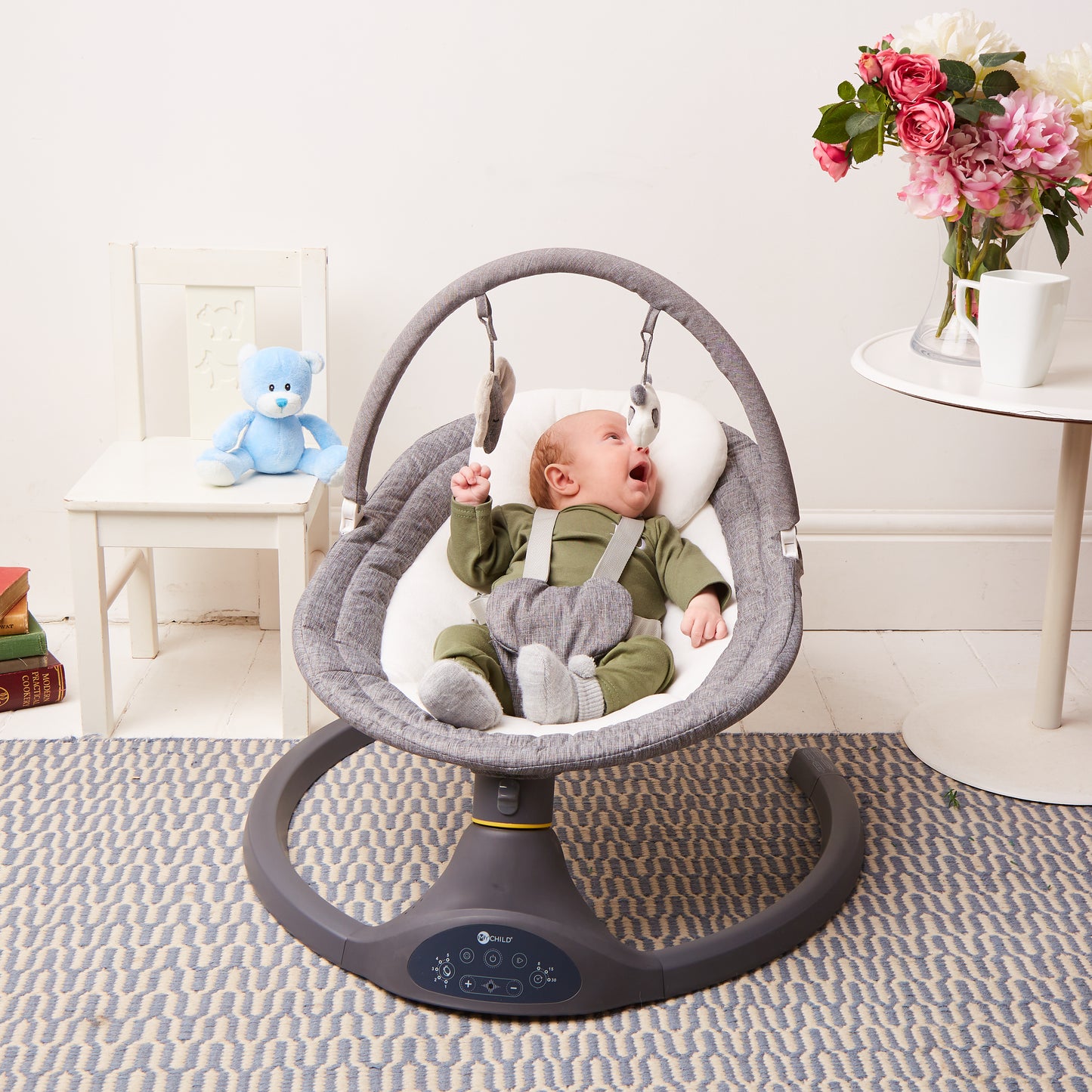 Baby resting in MyChild Drift rocker in living room, side-to-side swing