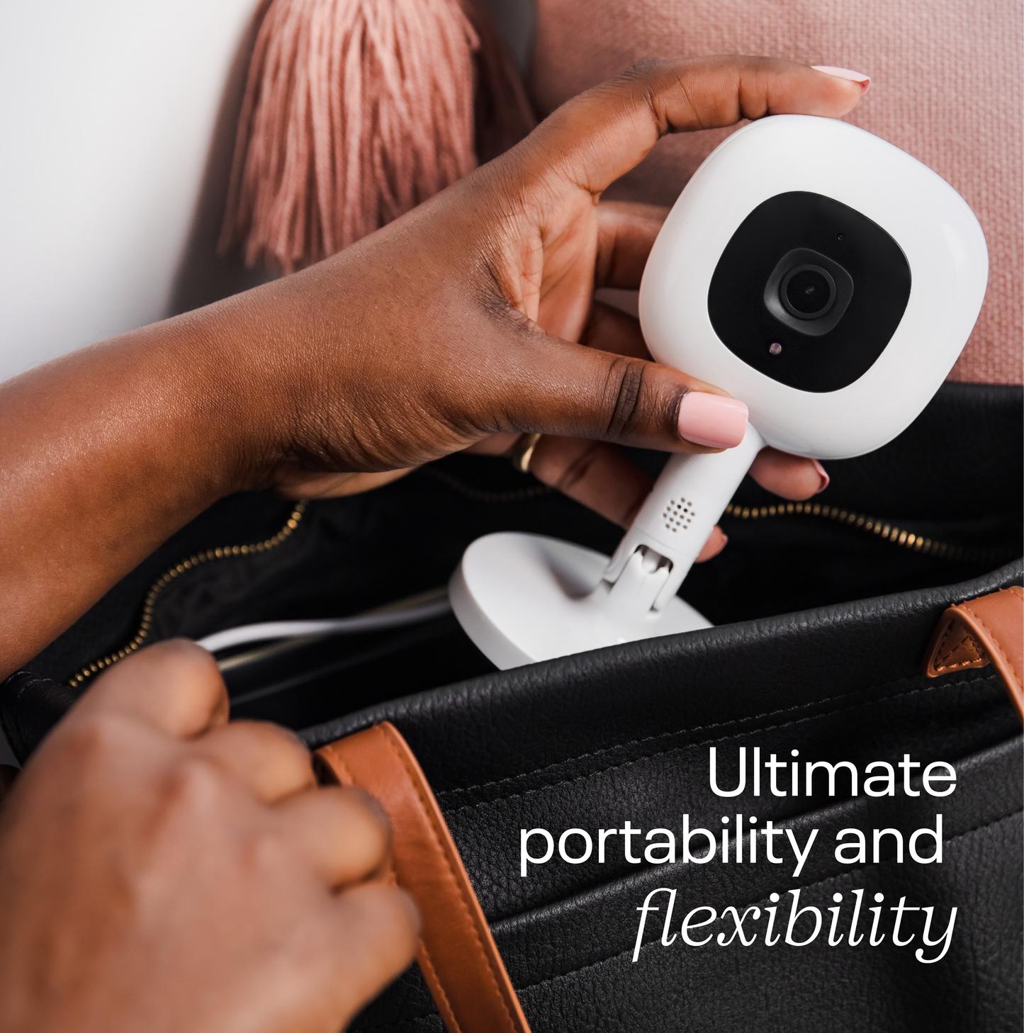 Hands attaching Nanit Flex Stand for portable monitoring