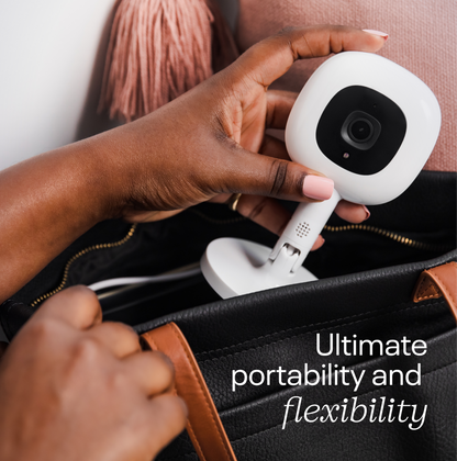 Hands attaching Nanit Flex Stand for portable monitoring